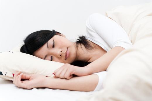 A woman asleep on a designer pillow.